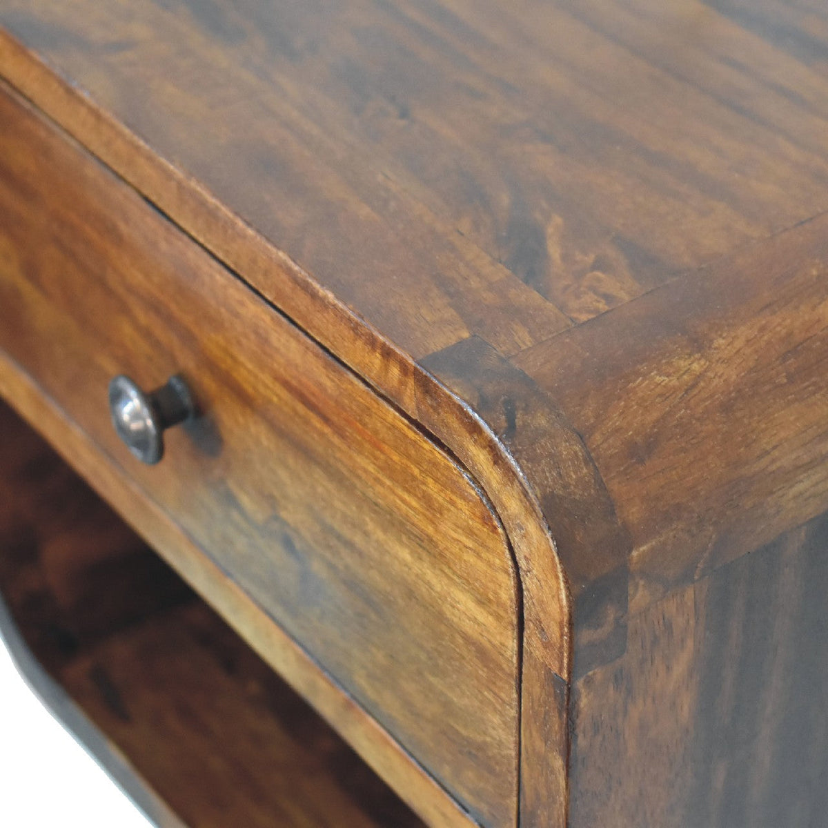 Detail view of the Curved Floating Mini Bedside Shelf's solid mango wood grain