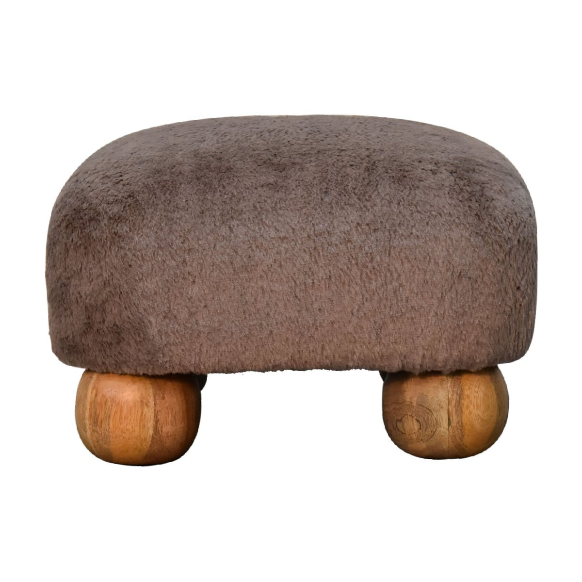 Faux Fur Nordic Footstool styled beside an armchair