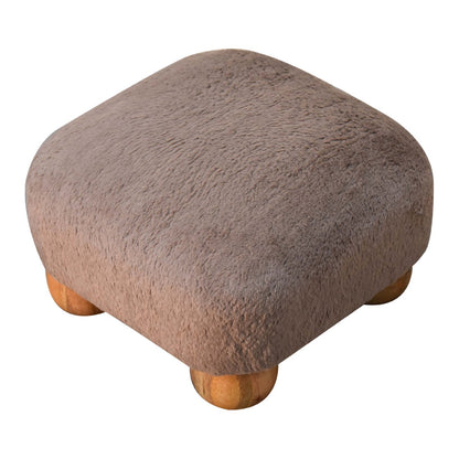 Close-up of the Faux Fur Nordic Footstool's solid mango wood bun feet