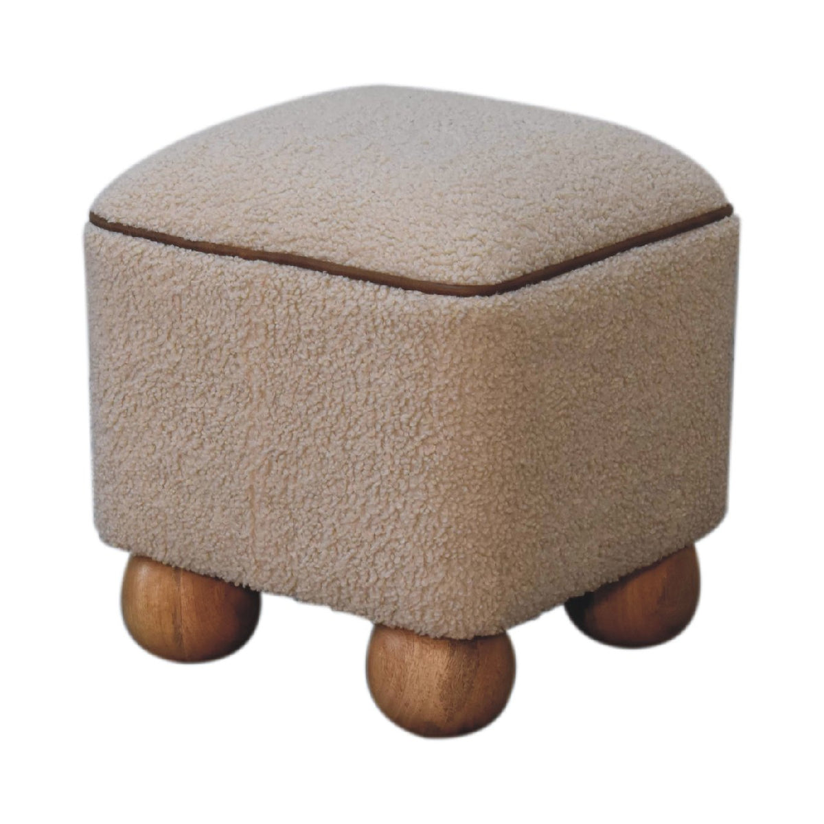 Close-up of the Boucle Footstool's solid mango wood ball feet